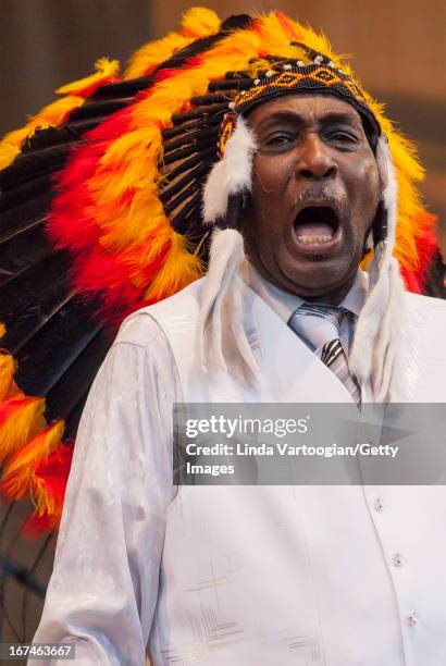 American blues musician Eddy Clearwater wears a Native American-style headdress as he leads the West Side Strut Band during a performance on the...