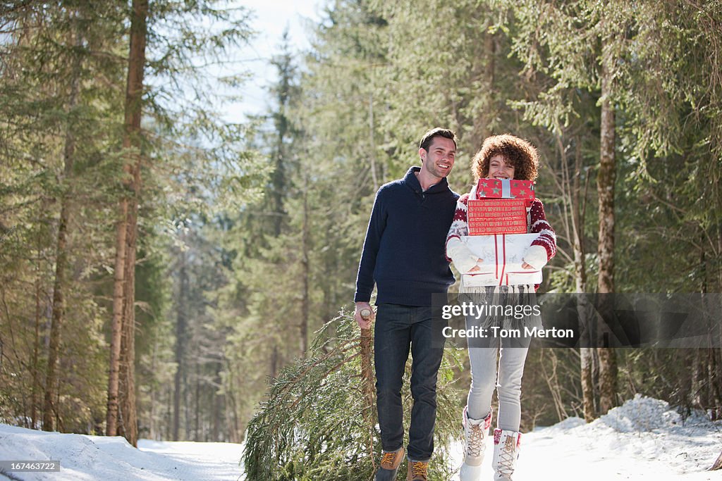 Man and woman with gifts outdoors, winter