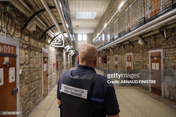 Prison guard stands in the cell corridor of the prison of Besancon, eastern France on September 13, 2023.