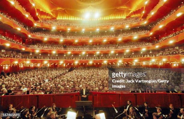 General view of the audience and the Metropolitan Opera Orchestra, with American artistic director and conductor James Levine, on the opening night...