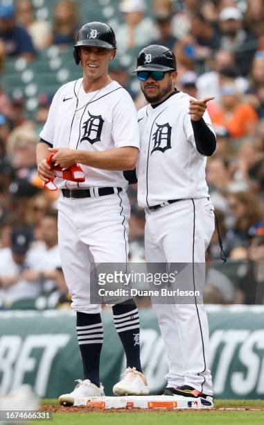 Kerry Carpenter of the Detroit Tigers talks with first base coach Alfredo Amezaga after hitting a single against the Chicago White Sox at Comerica...