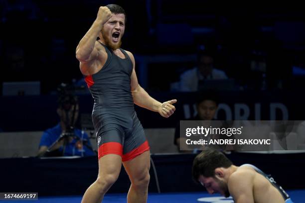 Russia's Akhmed Usmanov celebrates his victory over Georgia's Vladimir Gamkrelidze in the men's 79kg freestyle wrestling final match, during the...