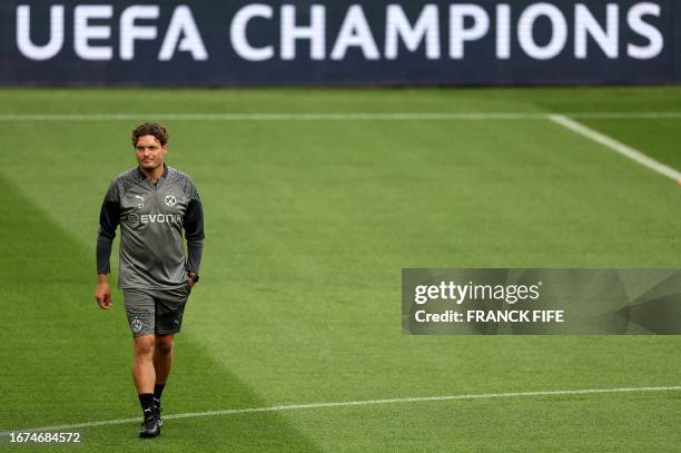 Dortmund's German head coach Edin Terzic walks on the pitch during a training session at the Parc des Princes stadium in Paris on September 18, 2023...