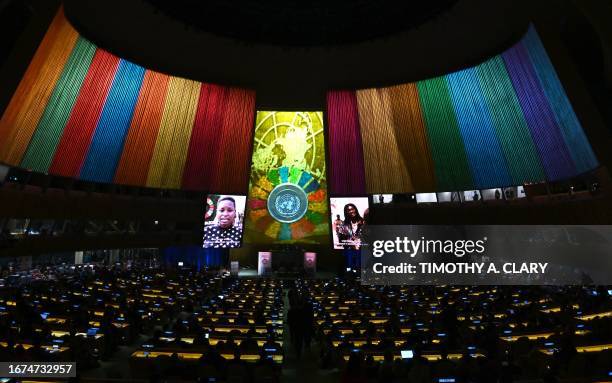 Video is displayed during the opening session of the second Sustainable Development Goals Summit in New York City on September 18 ahead of the 78th...