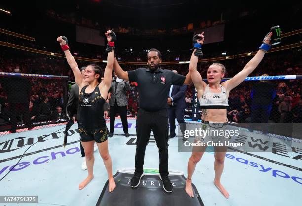 Alexa Grasso of Mexico and Valentina Shevchenko of Kyrgyzstan react after fighting to a majority draw in the UFC flyweight championship fight during...