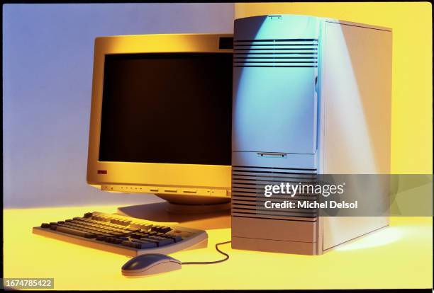 Digital computer, tower, keyboard and mouse on a yellow and blue background. Photo by Michel Delsol/ Getty Images