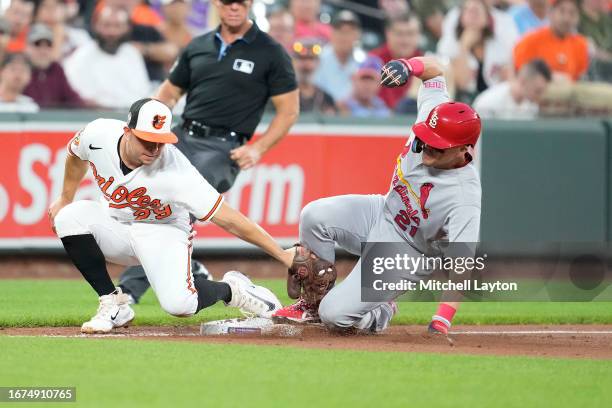 Lars Nootbaar of the St. Louis Cardinals beats the tag by Ramon Urias of the Baltimore Orioles to steal third base in the third inning during a...