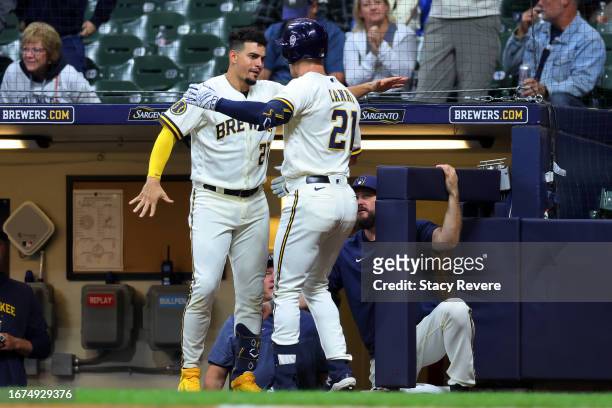 Mark Canha of the Milwaukee Brewers is congratulated by Willy Adames following a home run against the Miami Marlins during the first inning at...