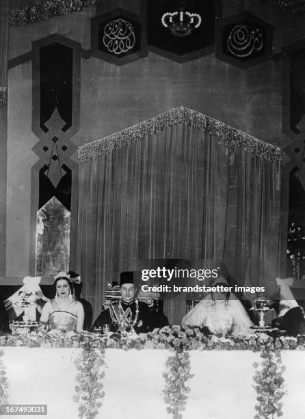 King Farouk with his wife Queen Farida and his mother Queen Nazil at a wedding banquet. Koubbeh Palace in Cairo. Egypt. Photograph. 1938. König...