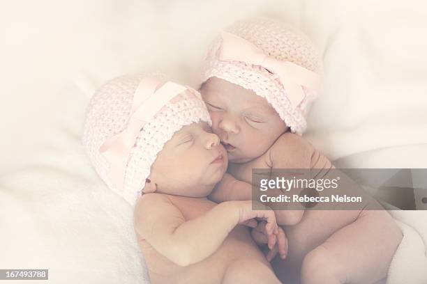 newborn twin girls in pink hats