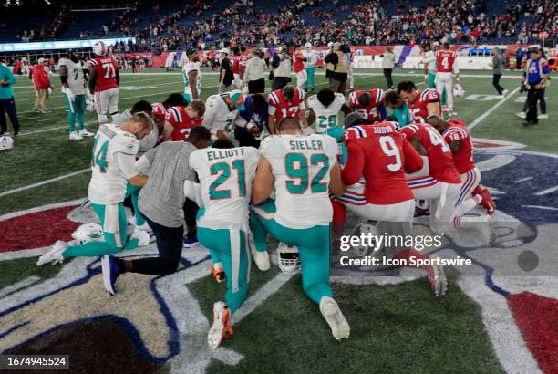 Players pray after a game between the New England Patriots and the Miami Dolphins on September 17 at Gillette Stadium in Foxborough, Massachusetts.