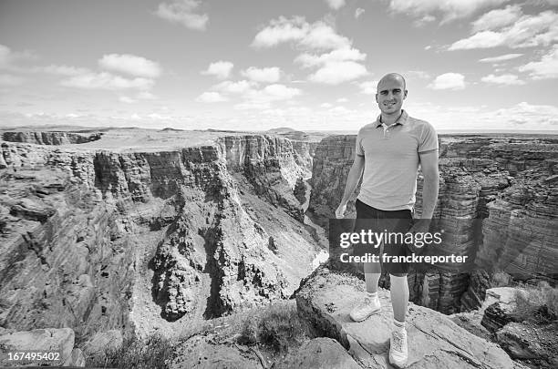 man on grand canyon rock peak - toroweap point stock pictures, royalty-free photos & images