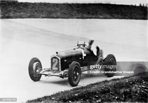 German racing driver Rudolf "Karratsch" Caracciola wins the race for the Grand Prix of Germany at the Nürburgring. 18th July 1932. Photograph. Rudolf...