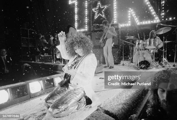 Marc Bolan performing with English glam rock group T-Rex at the Sundown, Edmonton, London, 22nd December 1972. In the background are drummer Mickey...