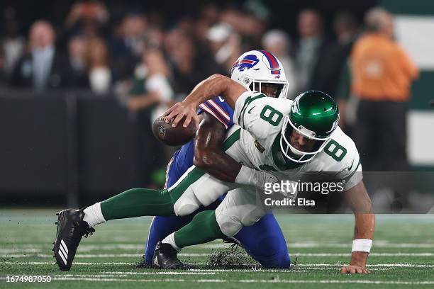 Quarterback Aaron Rodgers of the New York Jets sacked by defensive end Leonard Floyd of the Buffalo Bills during the first quarter of the NFL game at...