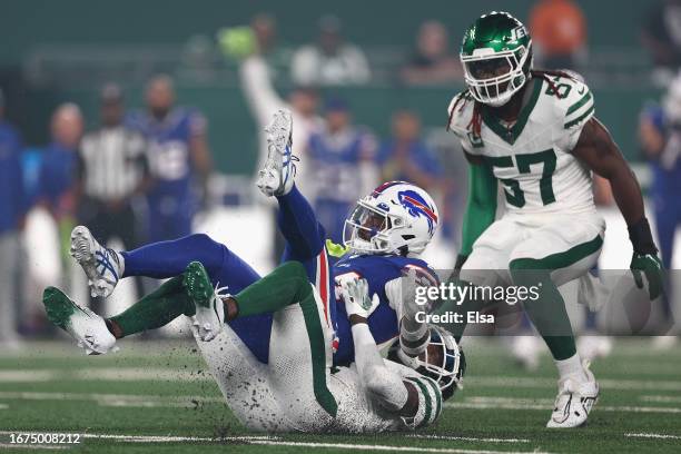 Wide receiver Stefon Diggs of the Buffalo Bills is tackled by cornerback Sauce Gardner of the New York Jets after a reception during the first...