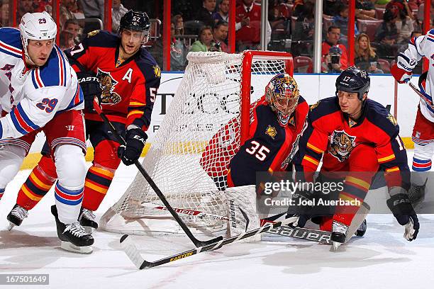 Filip Kuba assists Goaltender Jacob Markstrom of the Florida Panthers defend the net against Ryane Clowe of the New York Rangers at the BB&T Center...