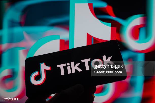 TikTok displayed on a smartphone with TikTok Icon seen in the background, in this photo illustration. On 18 September 2023, in Brussels, Belgium.