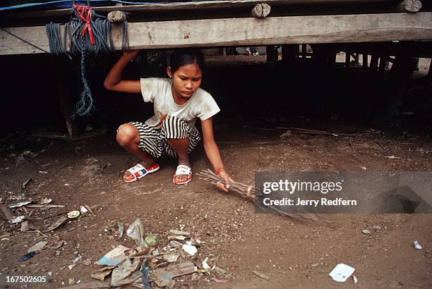 Na Roeun helps to clean up the yard of the Cambodian Light Children Association orphanage. All kids at the center help in chores. Pat Noun started...