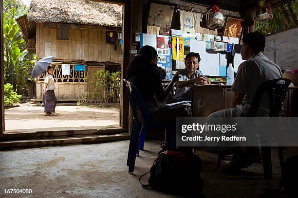 Sherryl Reddy, left, who works with UNHCR from their Mae Hong Son office, talks with the leader of the Mae Ra Ma Luang camp, Saw Baw Boe, in his...