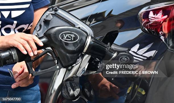 Person pumps gas into their vehicle at a gas station in Rosemead, California, on September 18, 2023. Oil prices hit a 10-month high on September 15...