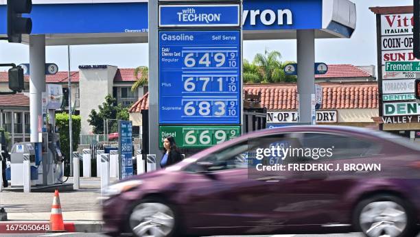 Sign displays the price of gas at more than 6 USD per gallon, at a petrol station in Alhambra, California, on September 18, 2023. Oil prices hit a...