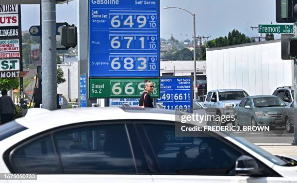 Sign displays the price of gas at more than 6 USD per gallon, at a petrol station in Alhambra, California, on September 18, 2023. Oil prices hit a...