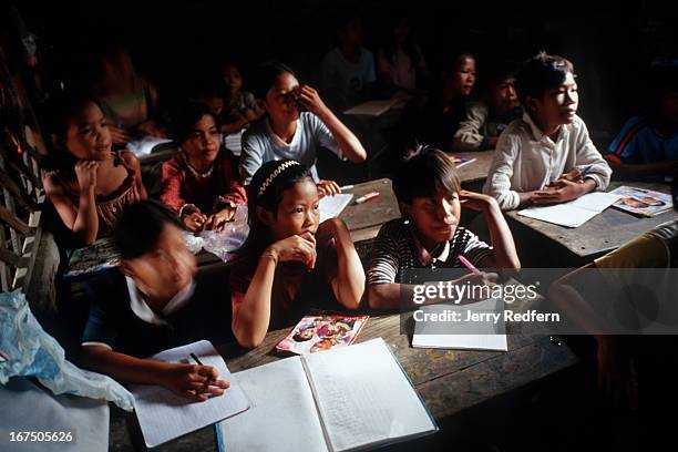 Students listen to their teacher during a math class at the Cambodian Light Children Association. The orphanage also teaches kids from the...