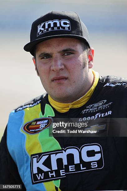 Austin Dyne, driver of the KMC Wheels Chevrolet, stands on the grid during qualifying for the NASCAR K&N Pro Series East Blue Ox 100 at Richmond...