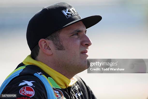 Austin Dyne, driver of the KMC Wheels Chevrolet, stands on the grid during qualifying for the NASCAR K&N Pro Series East Blue Ox 100 at Richmond...