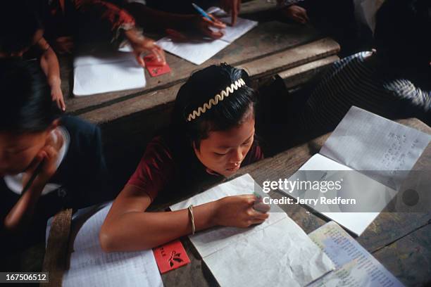 Sambo finishes a lesson during a math class at the Cambodian Light Children Association. The orphanage also teaches kids from the surrounding...