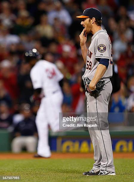 Philip Humber of the Houston Astros reacts after he gave up a home run to David Ortiz of the Boston Red Sox, seen rounding third base in the 3rd...