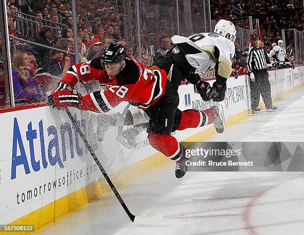 Anton Volchenkov of the New Jersey Devils hits Pascal Dupuis of the Pittsburgh Penguins during the first period at the Prudential Center on April 25,...