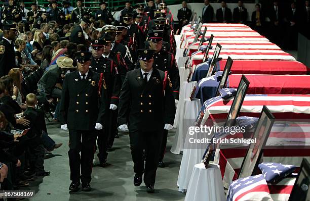 Firefighter honor guard marches past the caskets of the 12 fallen volunteer firefighters at the West memorial service held at Baylor University April...