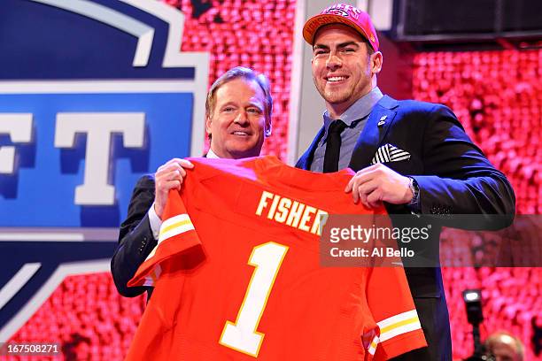 Eric Fisher of Central Michigan Chippewas stands on stage with NFL COmmissioner Roger Goodell after Fisher was picked overall by the Kansas City...