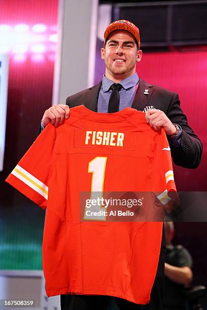 Eric Fisher of Central Michigan Chippewas holds up a jersey on stage after he was picked overall by the Kansas City Chiefs in the first round of the...