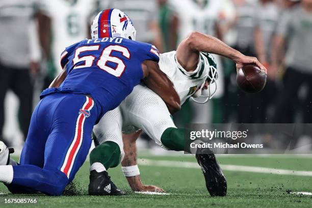 Aaron Rodgers of the New York Jets is sacked by Leonard Floyd of the Buffalo Bills during to a game at MetLife Stadium on September 11, 2023 in East...