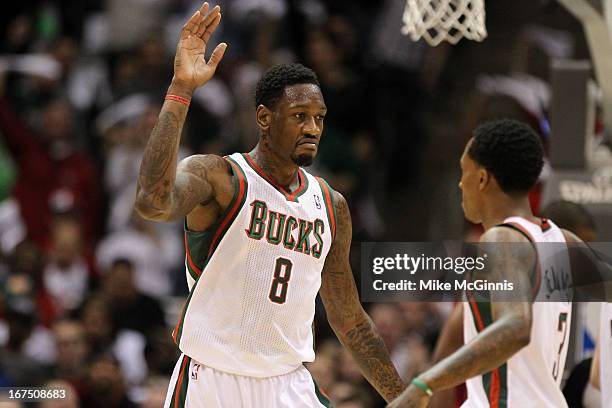 Larry Sanders of the Milwaukee Bucks high fives Brandon Jennings after drawing a foul against the Miami Heat during Game Three of the Western...