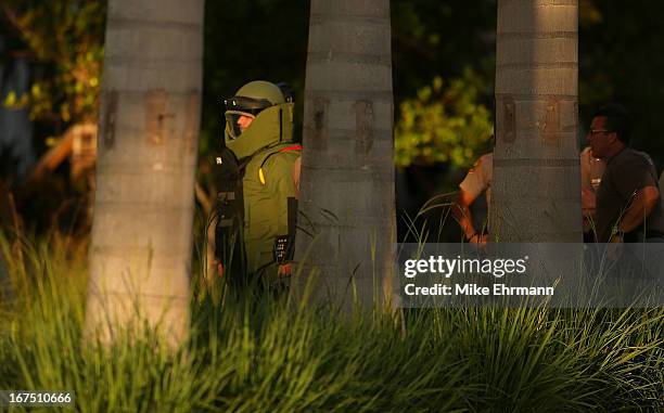 Members of the Miami Police Department's Bomb Squad investigate a package during a game between the Miami Marlins and the Chicago Cubs at Marlins...