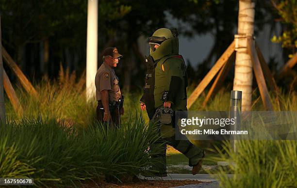 Members of the Miami Police Department's Bomb Squad investigate a package during a game between the Miami Marlins and the Chicago Cubs at Marlins...