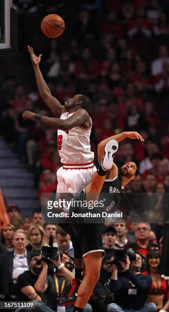 Loul Deng of the Chicago Bulls shoots over Deron Williams of the Brooklyn Nets in Game Three of the Eastern Conference Quarterfinals during the 2013...