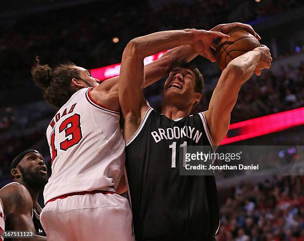 Joakim Noah of the Chicago Bulls fouls Brook Lopez of the Brooklyn Nets in Game Three of the Eastern Conference Quarterfinals during the 2013 NBA...
