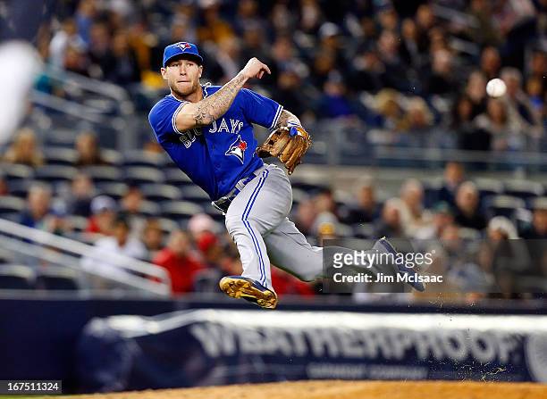 Brett Lawrie of the Toronto Blue Jays throws to first base in the seventh inning attempting an out against Ben Francisco of the New York Yankees at...