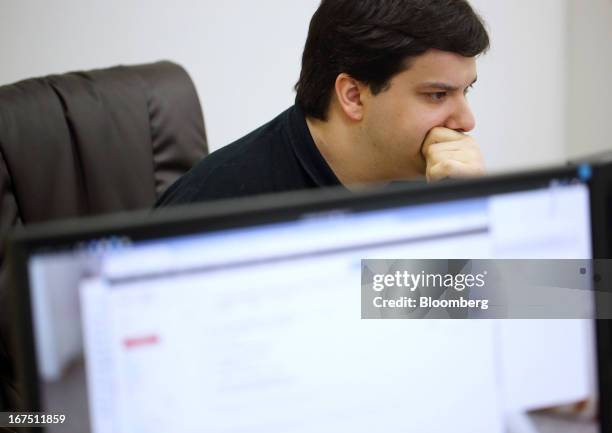 Mark Karpeles, chief executive officer of Tibanne Co., works at his desk in the office operating the Mt.Gox K.K. Bitcoin exchange in Tokyo, Japan, on...