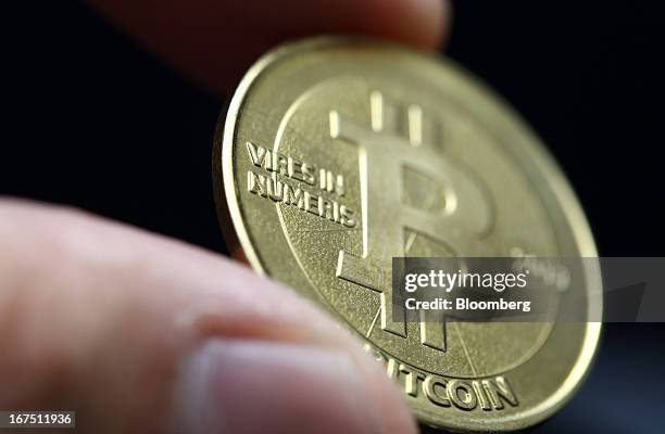 One bitcoin is arranged for a photograph in Tokyo, Japan, on Thursday, April 25, 2013. The digital currency, which carries the unofficial ticker...
