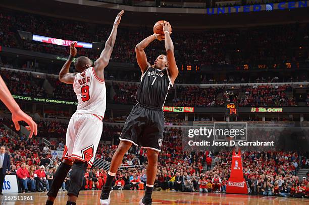 Joe Johnson of the Brooklyn Nets shoots against Luol Deng of the Chicago Bulls in Game Three of the Eastern Conference Quarterfinals during the 2013...