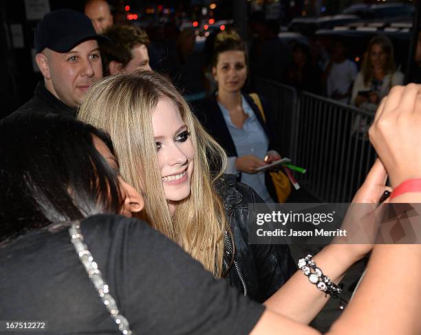 Singer Avril Lavigne takes a photo with a fan as she arrives for her secret performance at The Viper Room on April 25, 2013 in West Hollywood,...