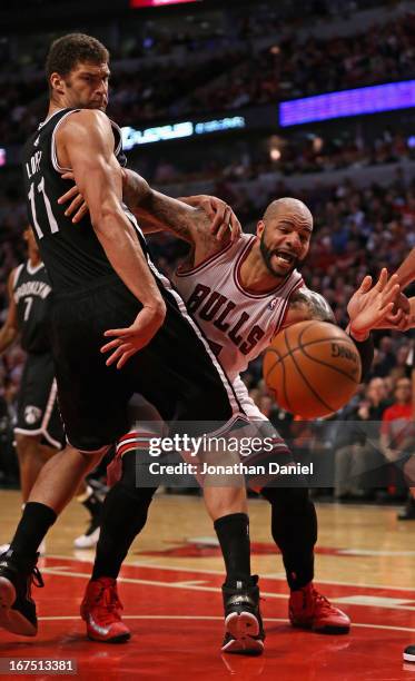 Brook Lopez of the Brooklyn Nets knocks the ball away from Carlos Boozer of the Chicago Bulls in Game Three of the Eastern Conference Quarterfinals...