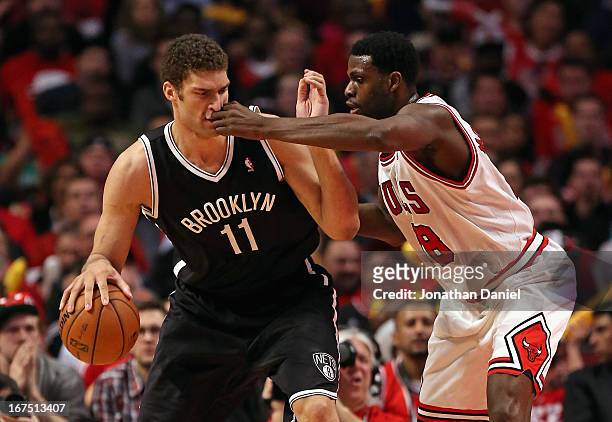 Nazr Mohammed of the Chicago Bulls hits Brook Lopez of the Brooklyn Nets in the face in Game Three of the Eastern Conference Quarterfinals during the...