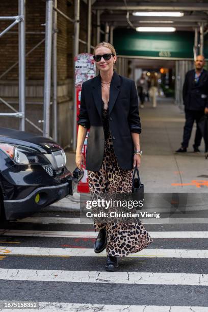 Lisa Aiken wears black blazer, leopard print dress outside Khaite on September 09, 2023 in New York City.